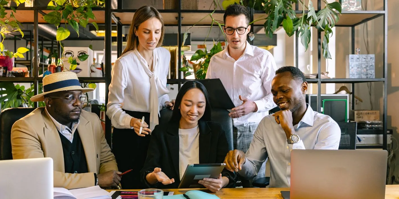 A small team reviewing work together at a desk